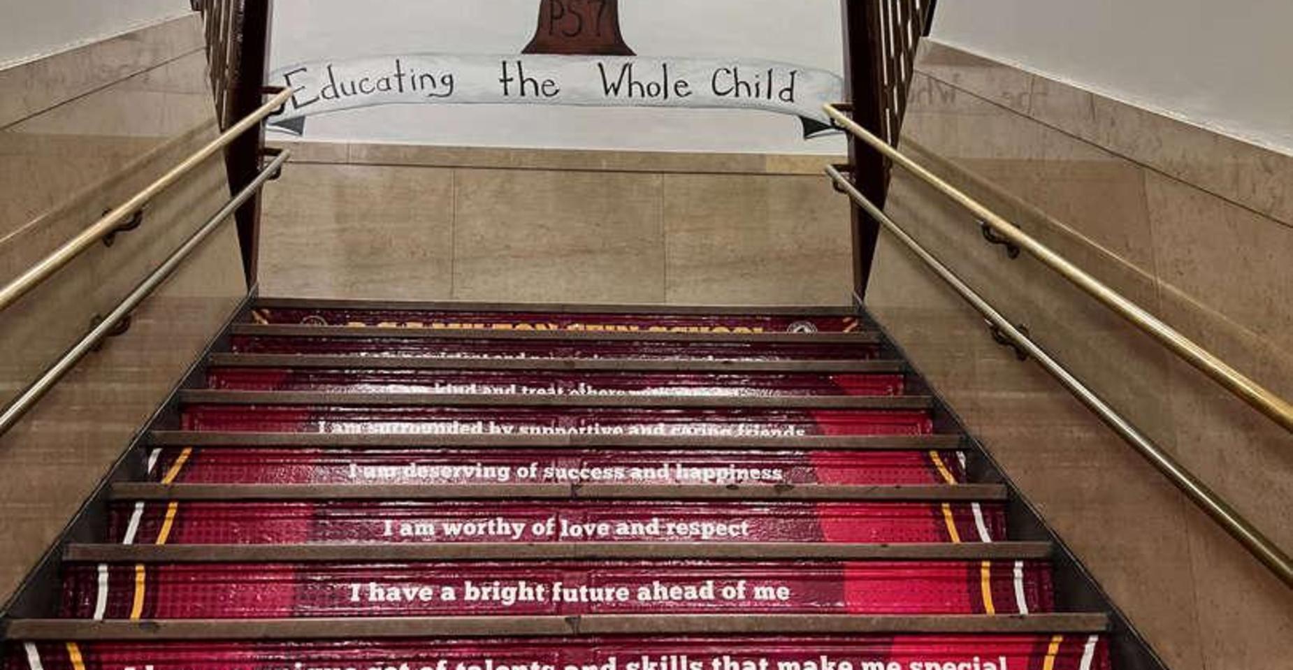Staircase with motivational quotes on the steps and a banner overhead.