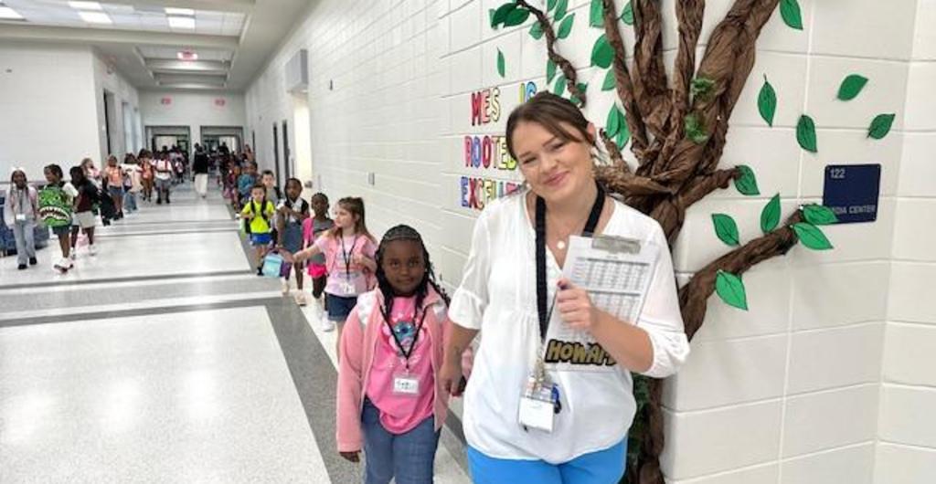 Teacher walking class down the hall