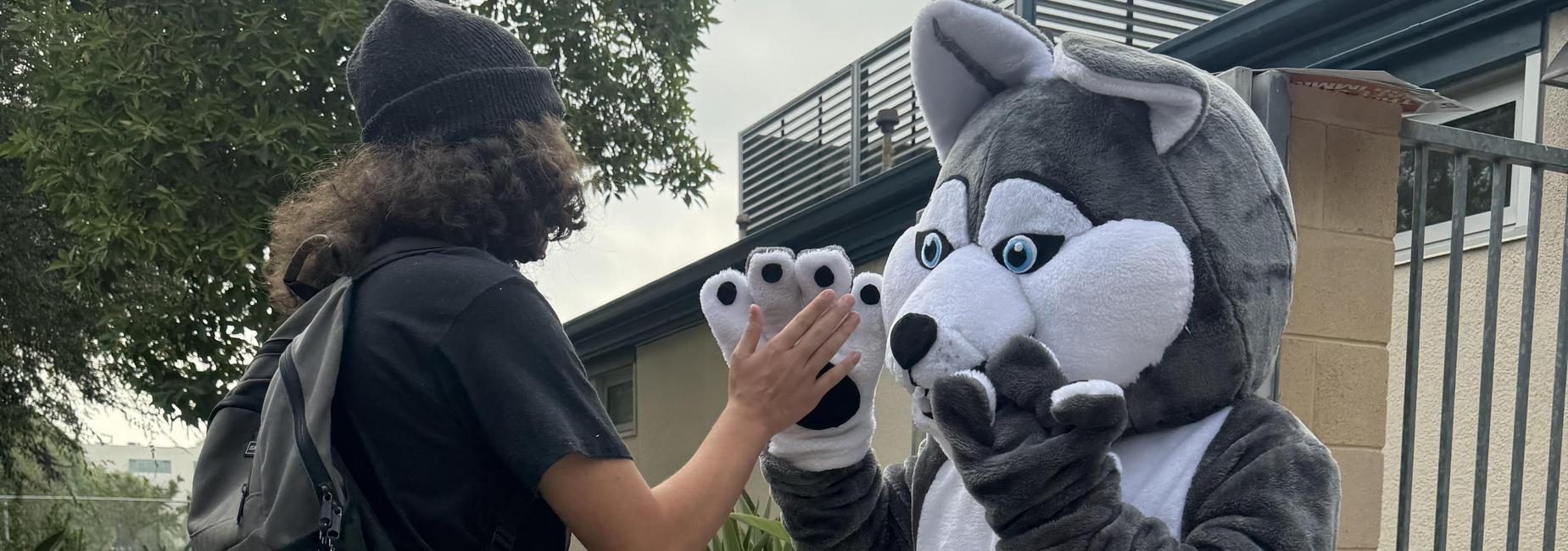 Hi-5 with our Mascot and our student.