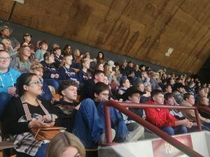 FFA members sitting together in the stands of the stadium watching the rodeo.