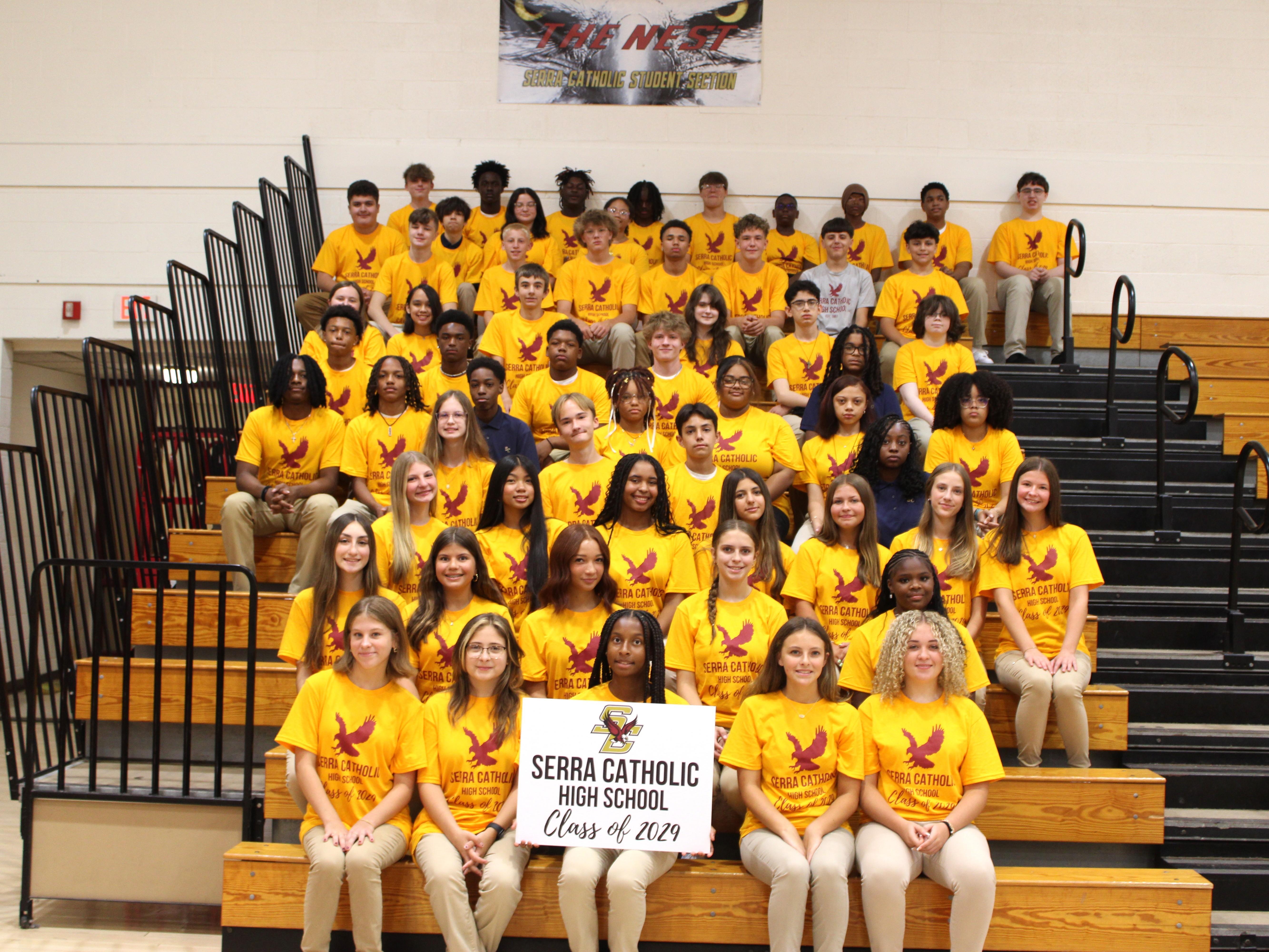 The Class of 2029 gathers for a group photo in the bleachers, wearing their Class of 2029 shirts.