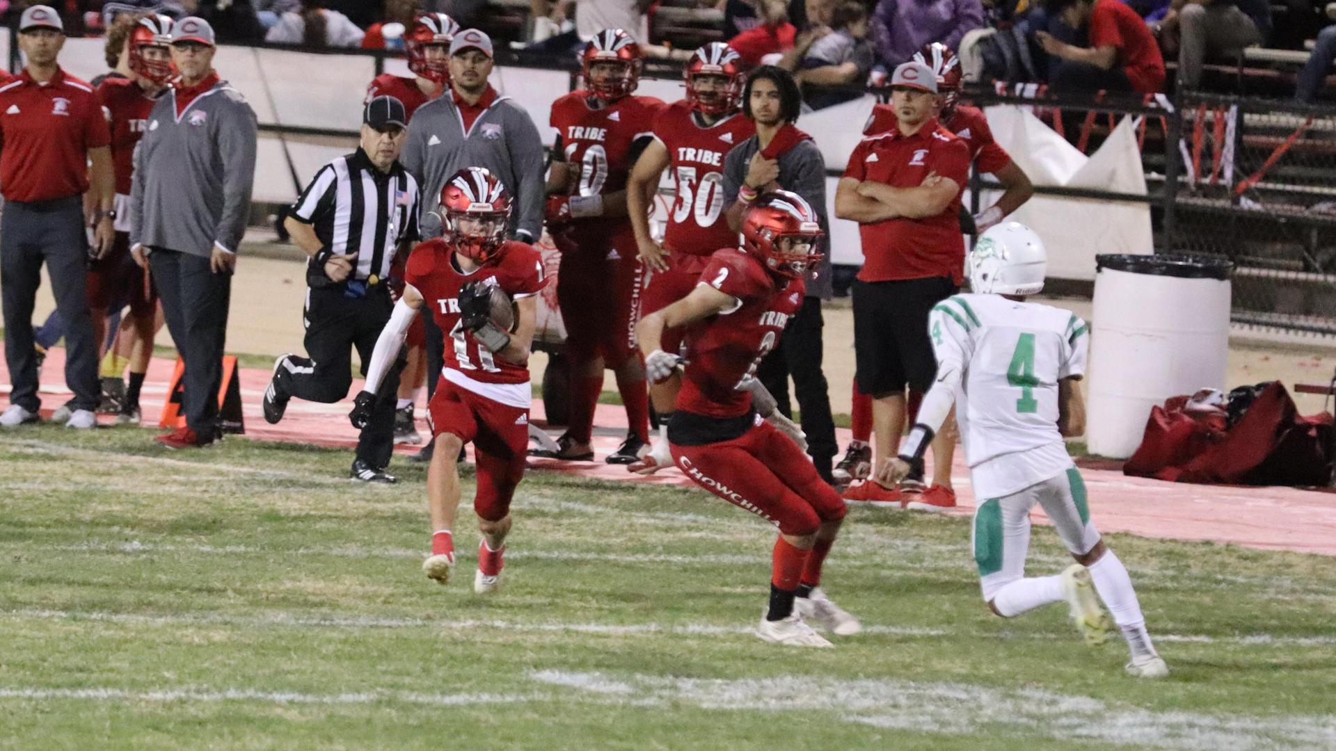 varsity football players in action against Riverdale