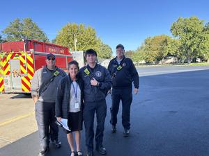 Locust Principal Mrs. Lopez stands with members of the Marengo Fire Department