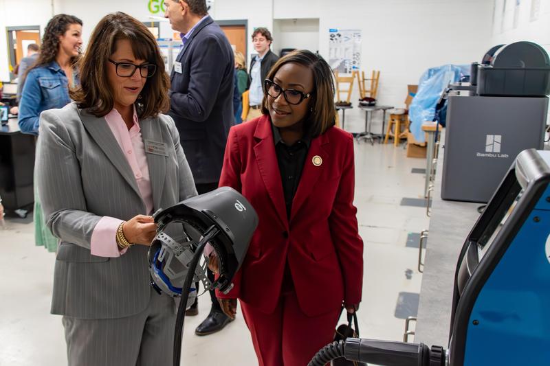 Delegate Kimberly Pope Adams (right) learns about the GO TEC welding station with Courtney Massengill (left), a GO TEC training coordinator, which uses augmented reality to simulate welding without the need for real-life units, while allowing students to learn essential skills in the always-in-demand career sector.