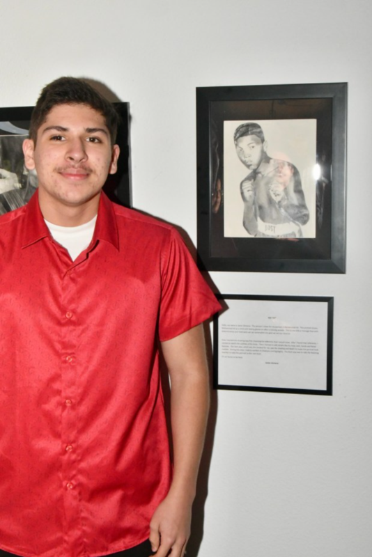 student next to his art of Muhammad Ali