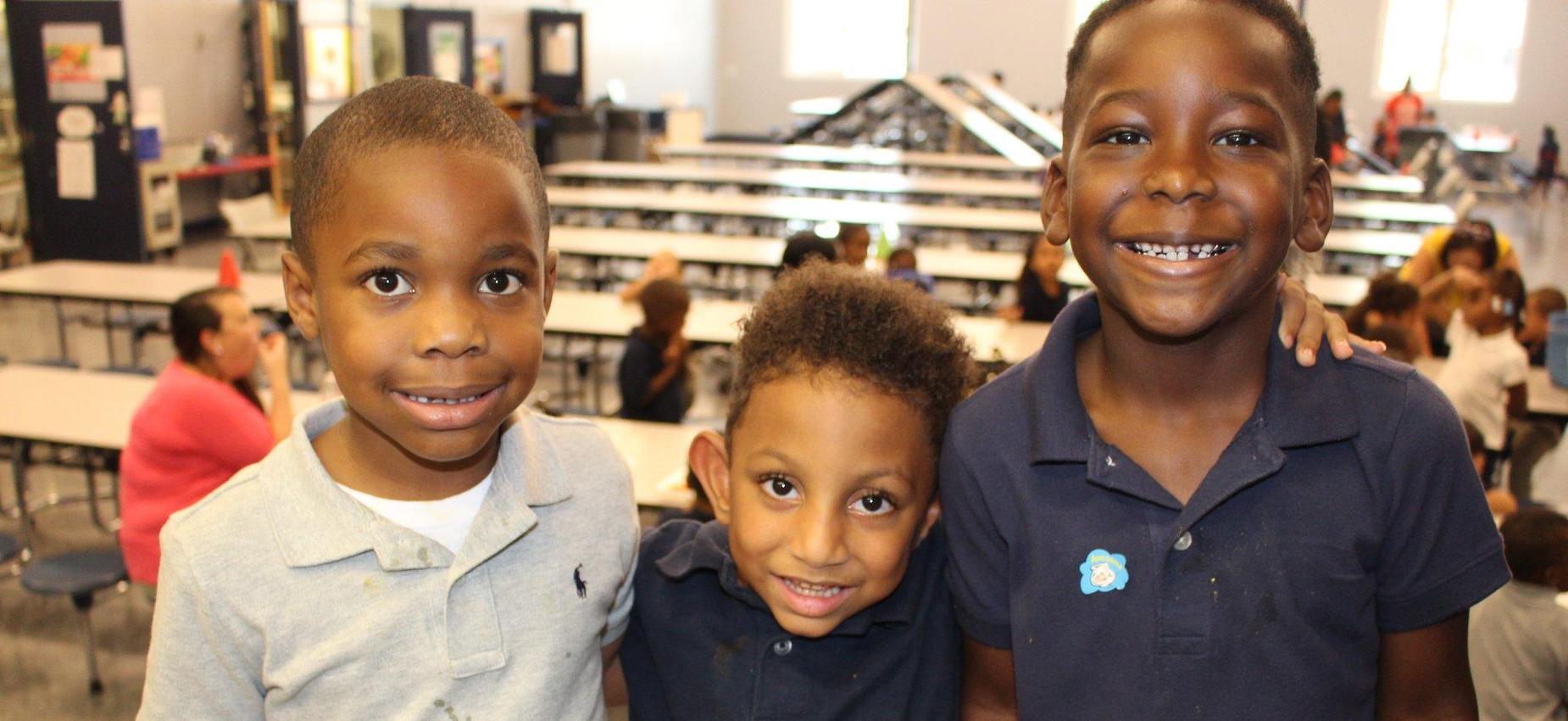 three boys smiling