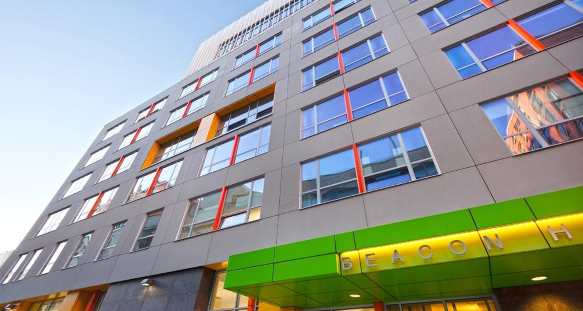 Contemporary building facade with colorful window accents labeled Beacon House.