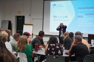 A presenter from Capturing Kids' Hearts talks to TK staff.