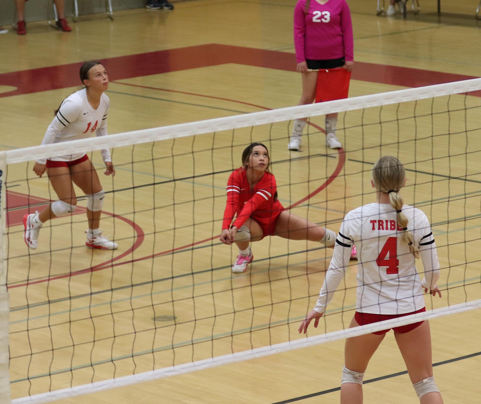 varsity volleyball players in action against Minarets
