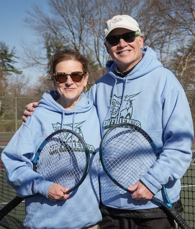 DVFriends tennis coaches Jeff and Roni Posing with tennis rackets.