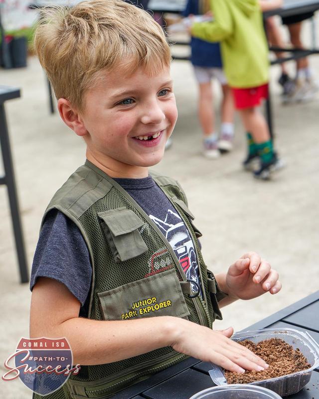 - Bill Brown first grader packing soil in a greenhouse.