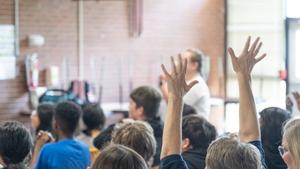 Image of audience raising hands