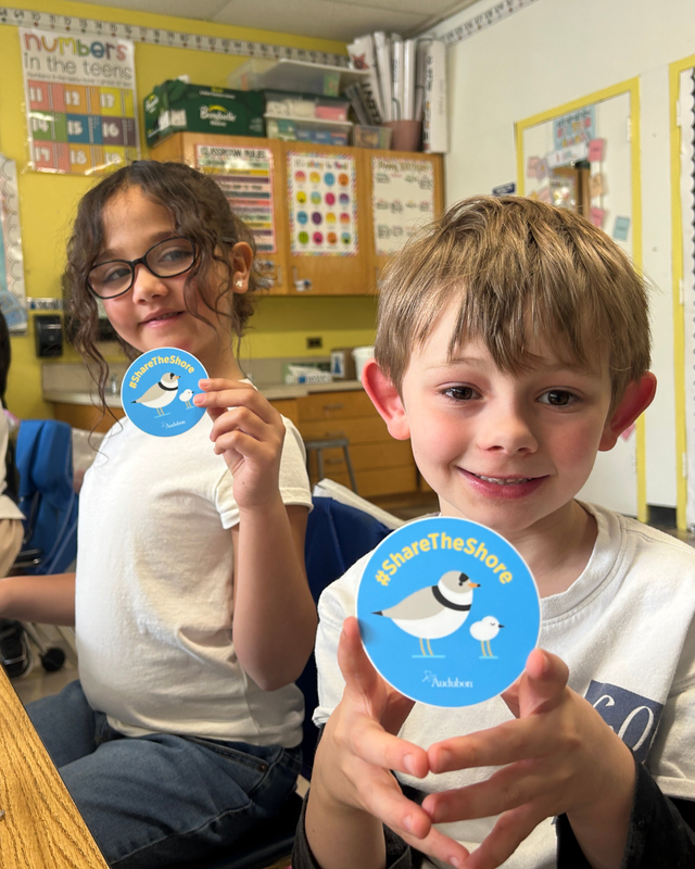 Students show Audobon stickers after lesson