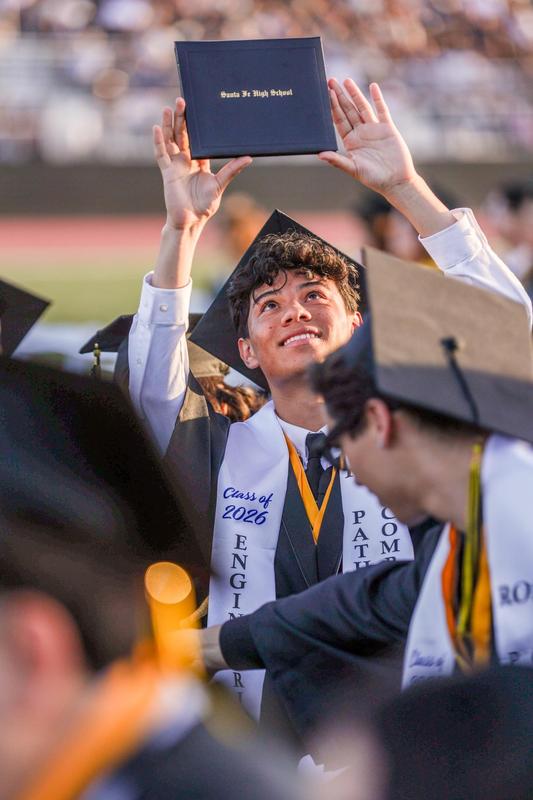 A male student from Santa Fe High School holds up his diploma during the ceremony.