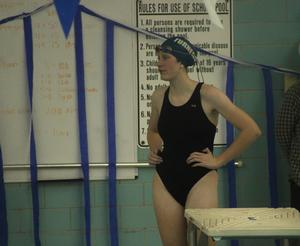 Girls team swimmer waits by the diving board for her meet