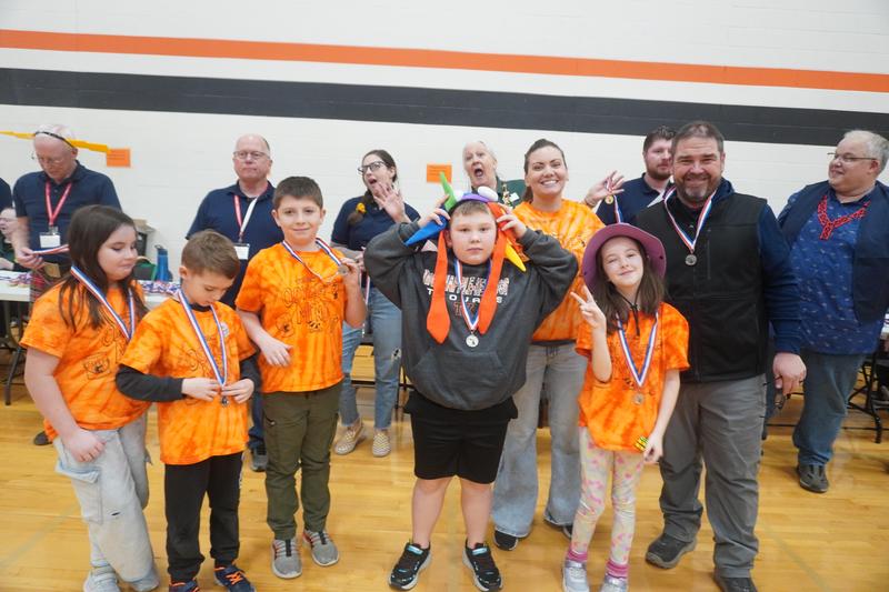 A TK OM team receives their medal at the regional competition.