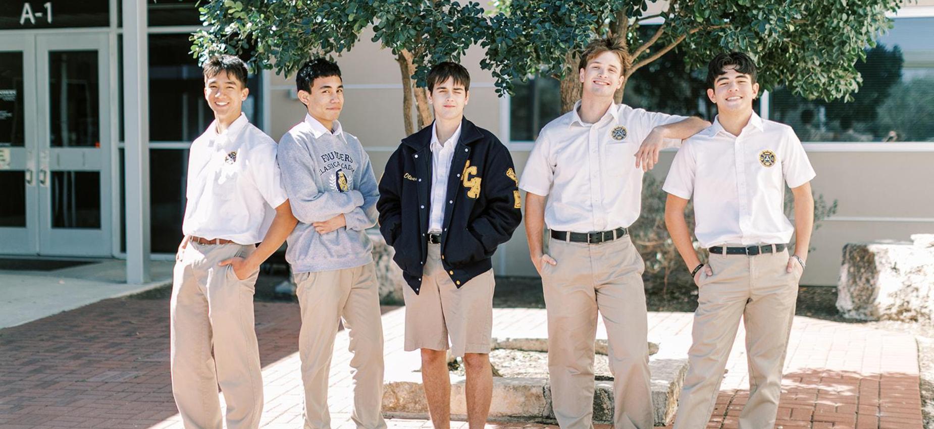 Five high school students in uniform stand together outside the school