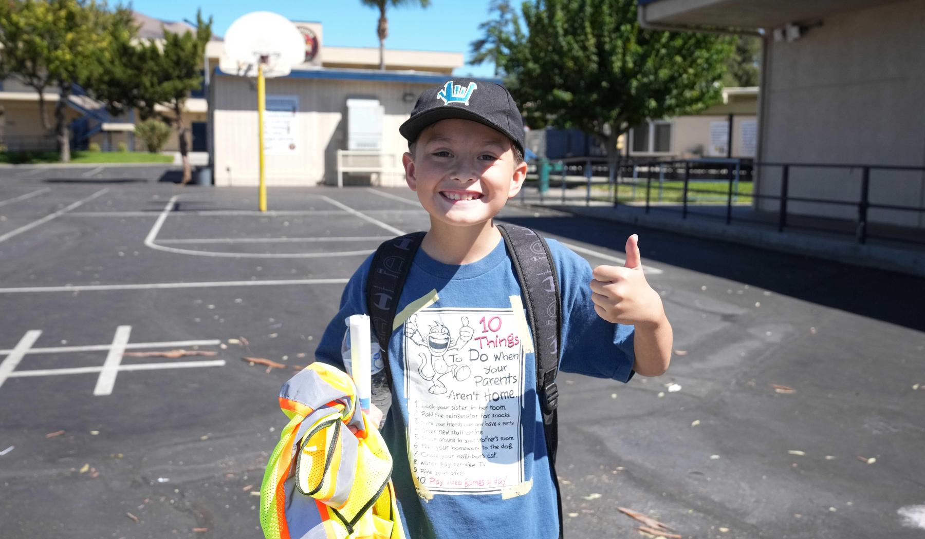 Boy smiling and giving a thumbs up on playground