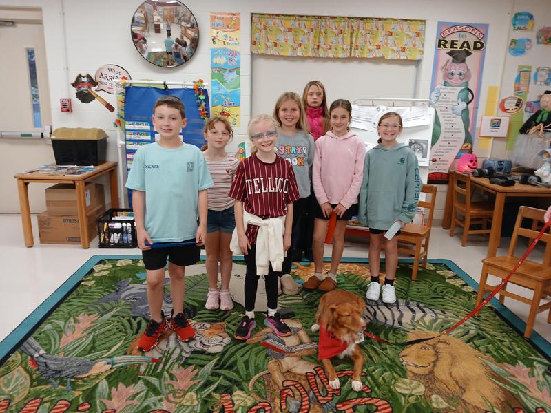 Pictures of students with HABIT Ruff Reading dog.