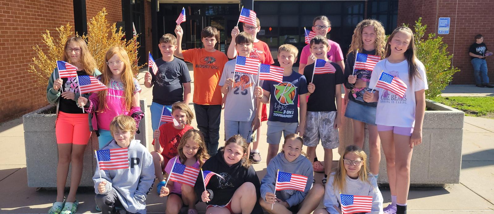 Students with small america flags