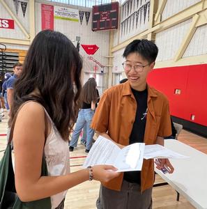 Two students holding class schedules