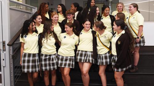 Saint Hubert students gather in group on staircase