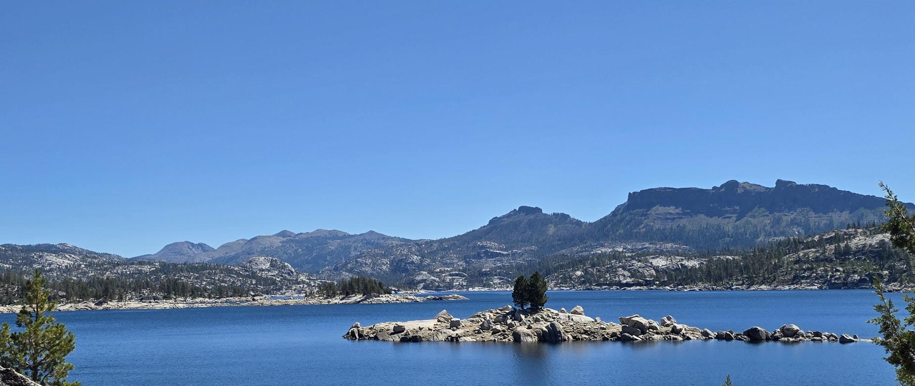 mountain lake with rock island in the middle