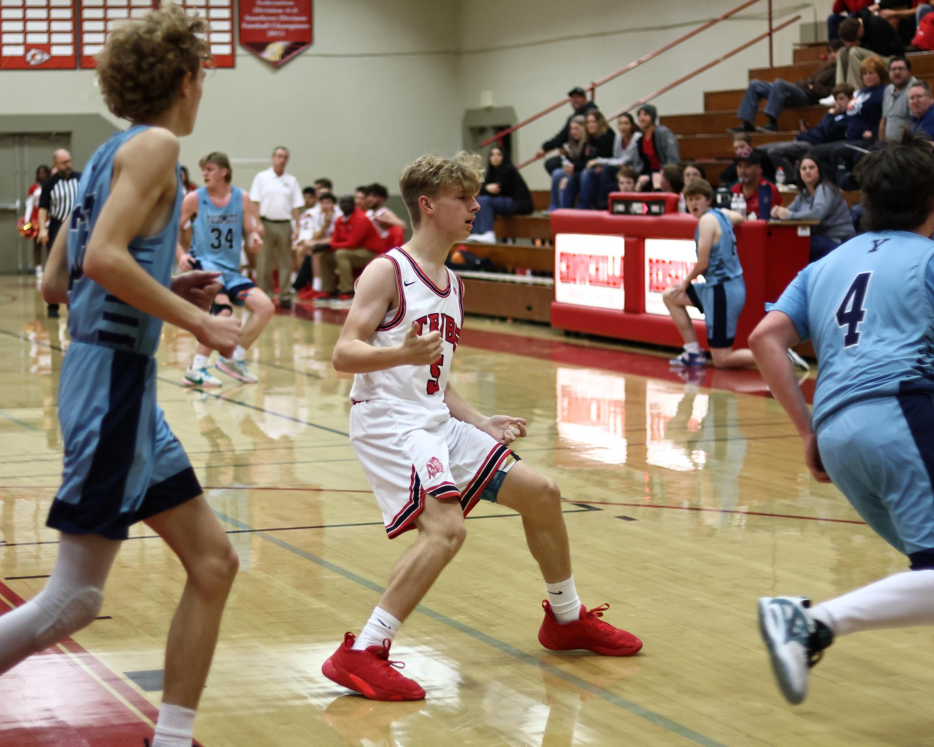 Varsity boys playing basketball against yosemite