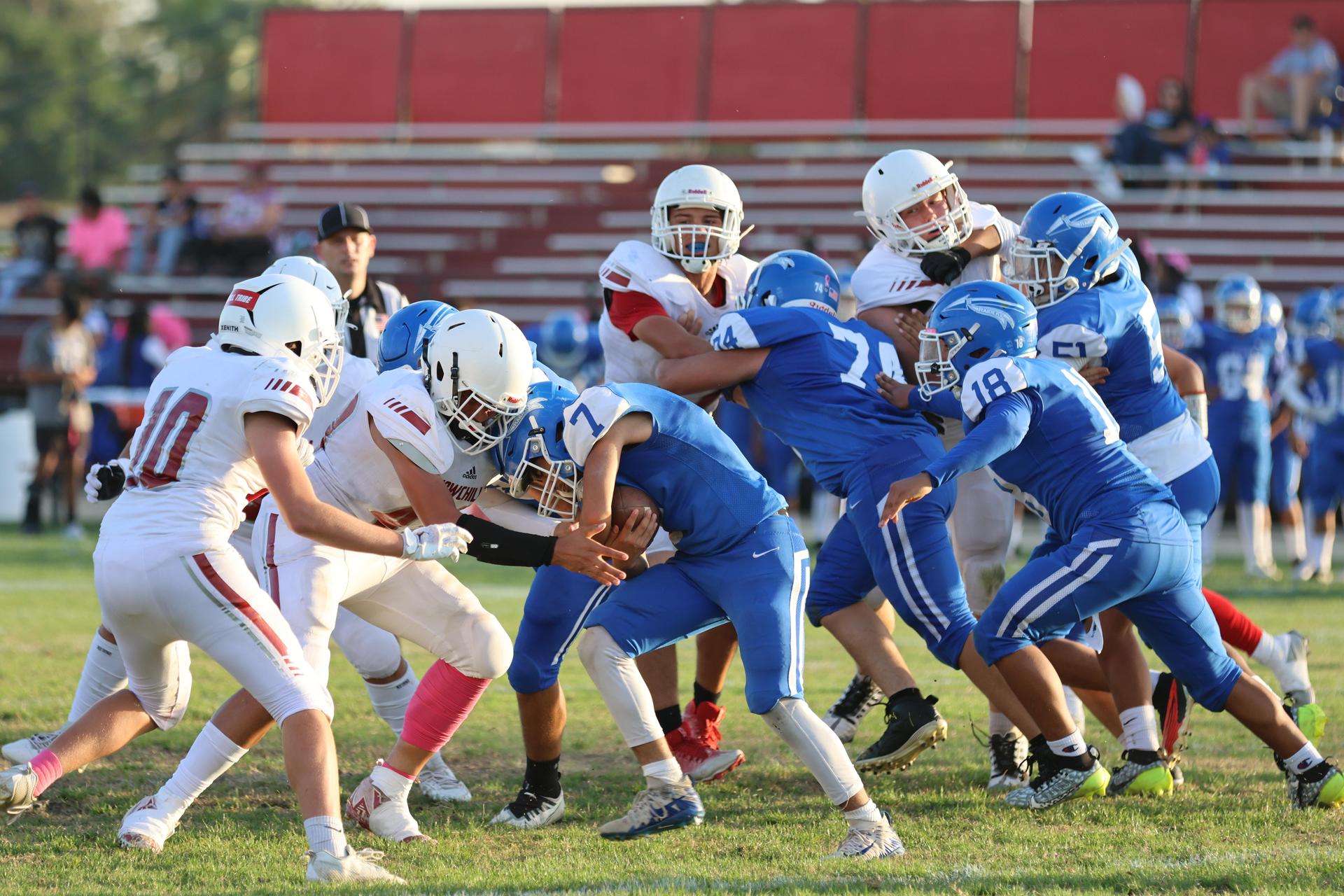 Junior Varsity football players in action against Caruthers