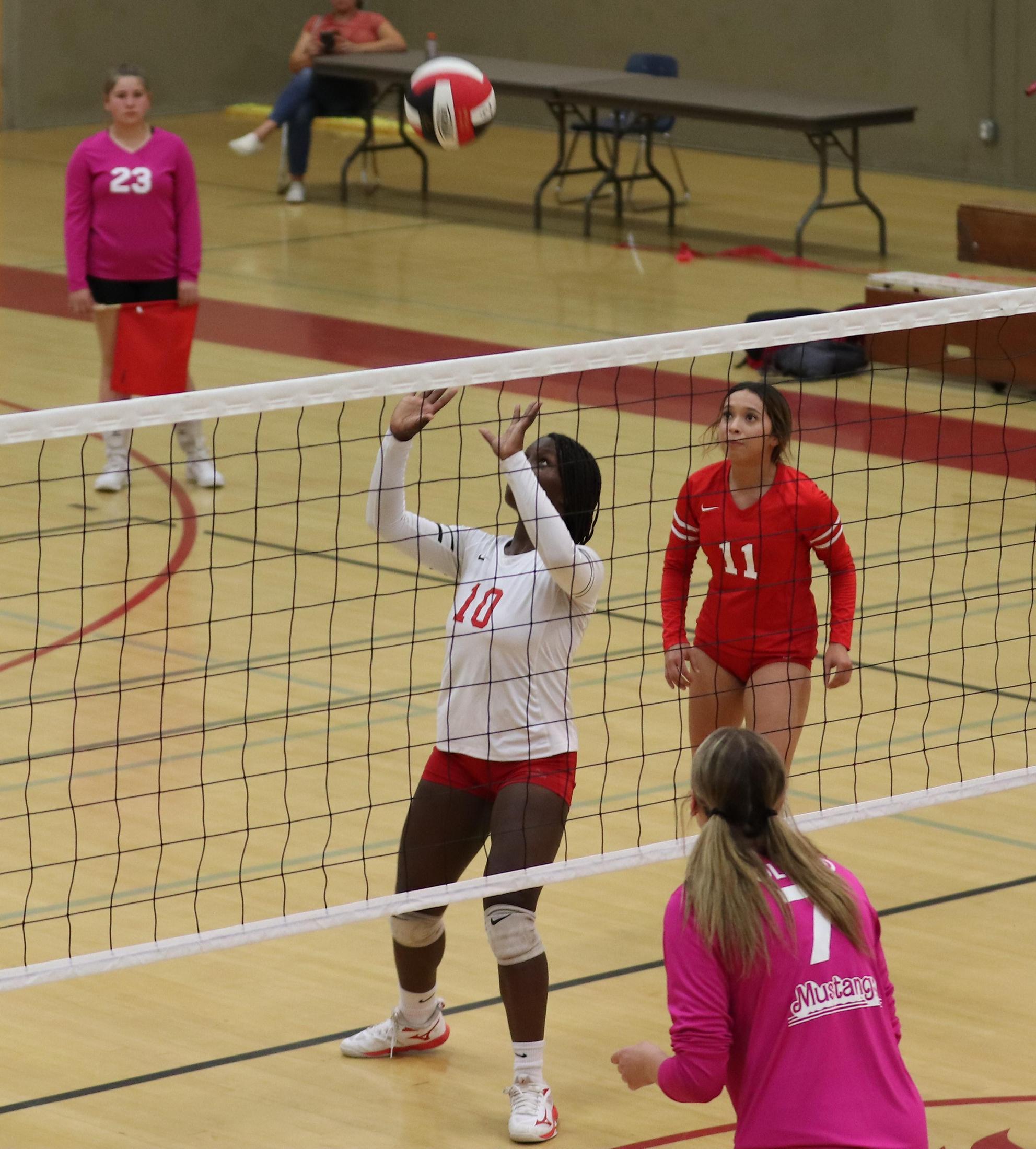 varsity volleyball players in action against Minarets