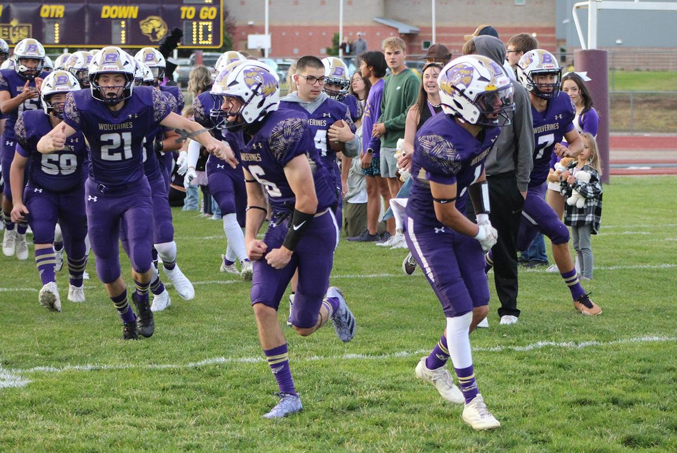 The football team takes the field.