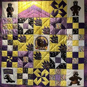 A purple and gold quilt.