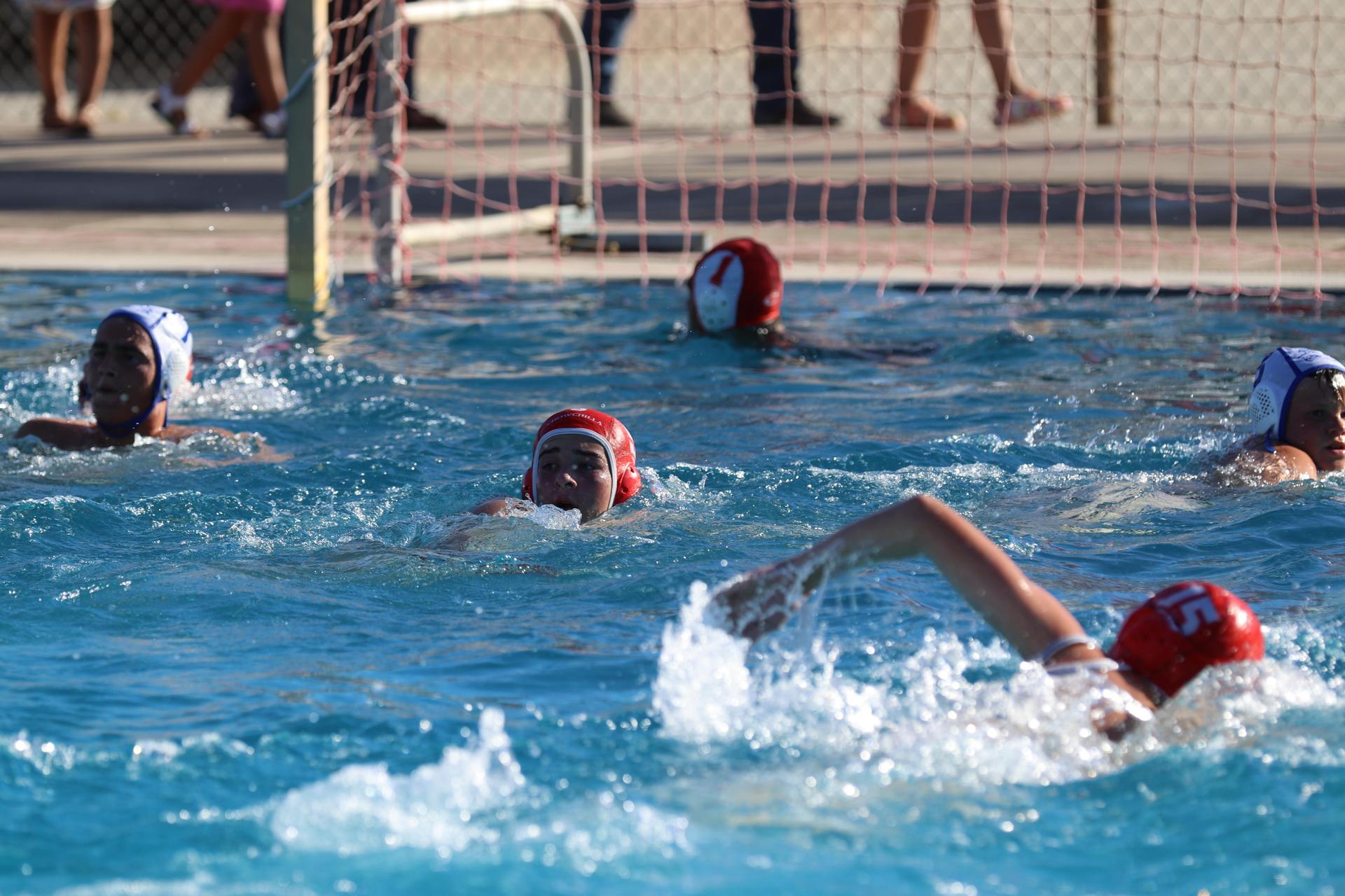 boys playing water polo against Madera