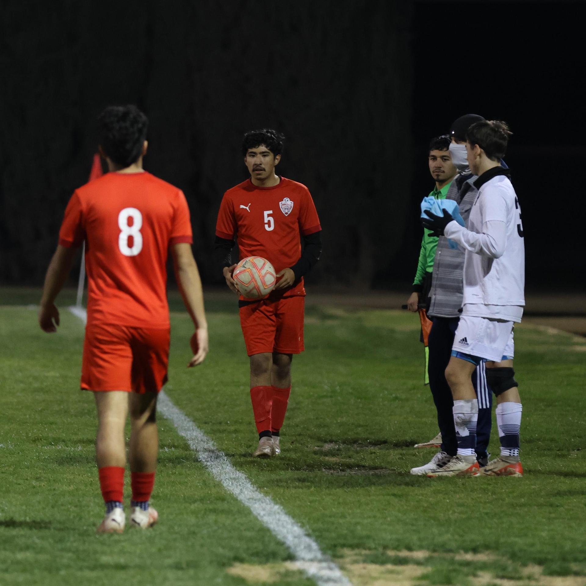 varisty boys soccer playing against yosemite