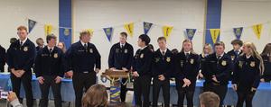 FFA Members who are seniors standing in front of the podium at banquet.