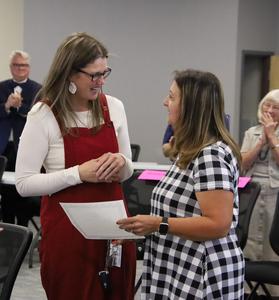Kelly Umbach receiving certificate from Trustee Alvey
