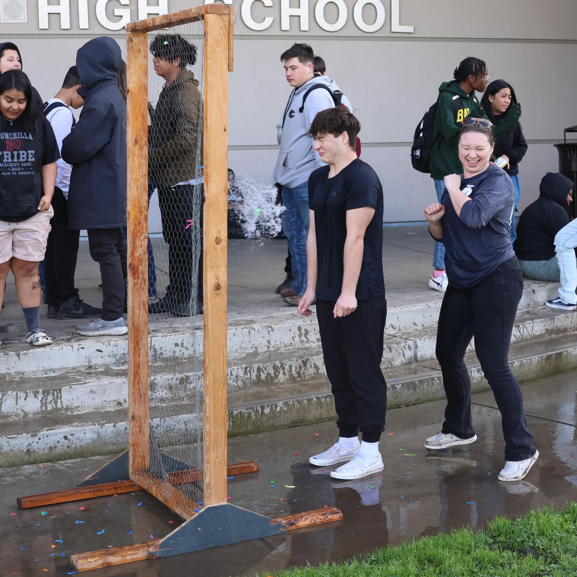 students and staff enjoying the water balloon toss