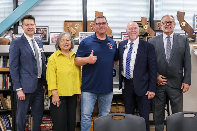Harmony Magnet Academy teacher Jeromy Blackwell gives a thumbs up after being surprised with the Central California Chinese Cultural Center High School Educator of the Year award.