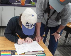 A student works on adding information to his observations.