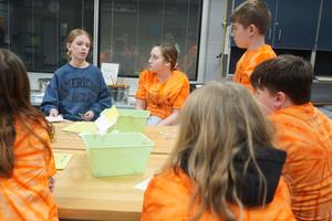 Team members listen to instructions for a challenge.