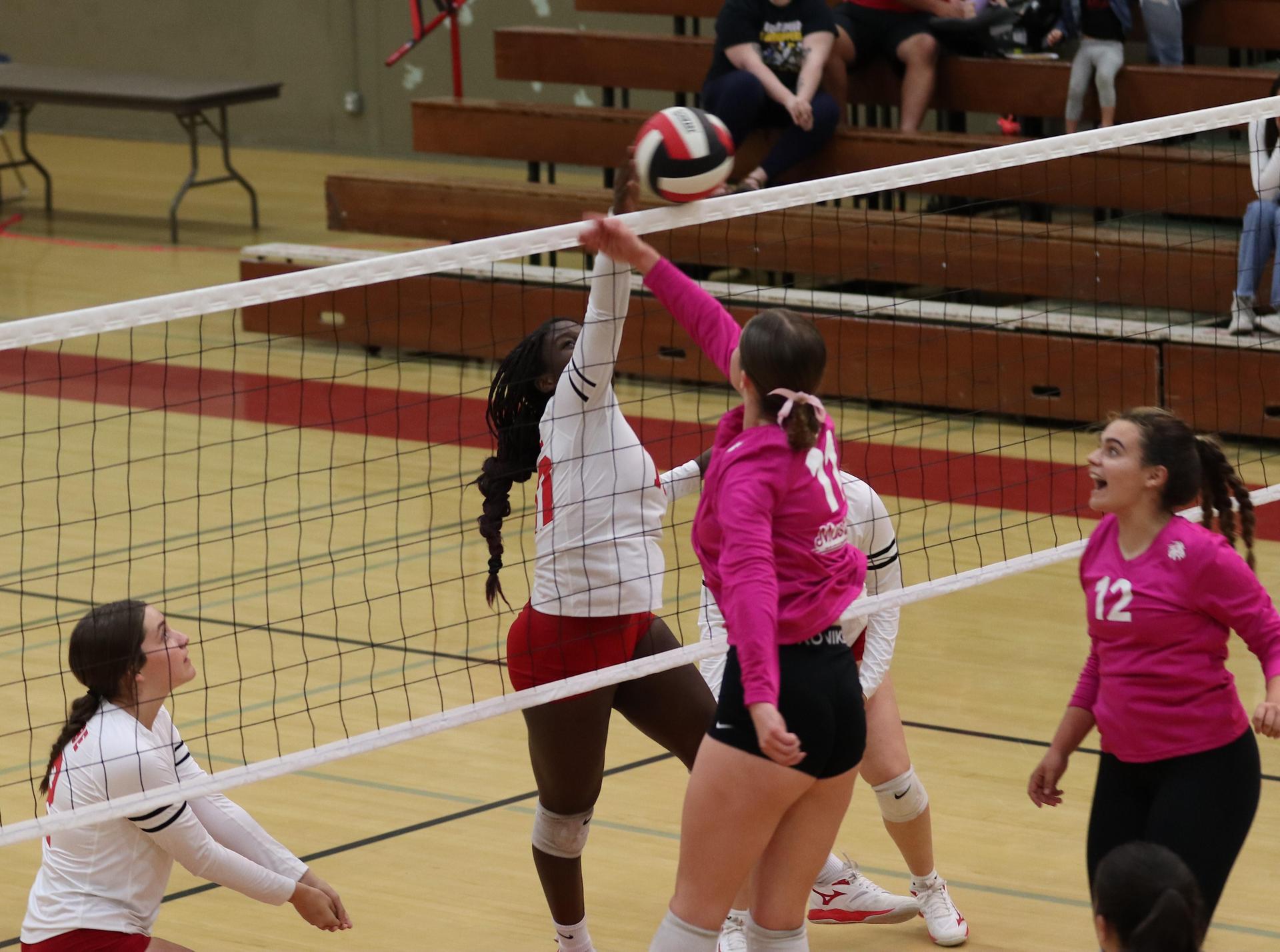 varsity volleyball players in action against Minarets