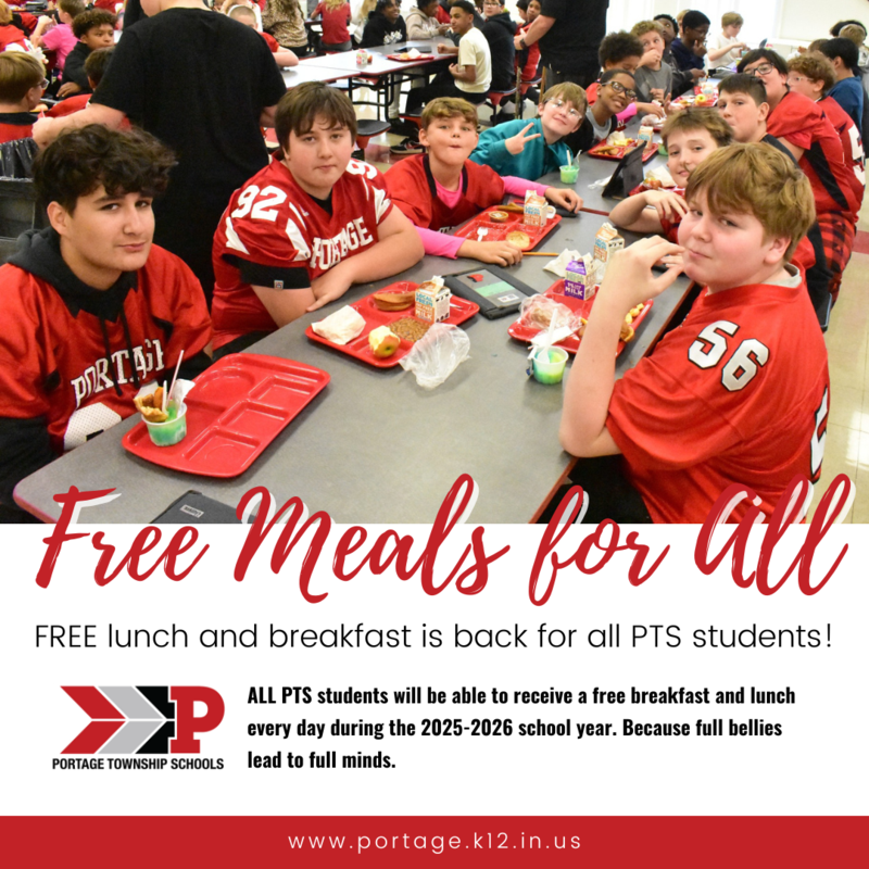 Students in red jerseys enjoy lunch together in a cafeteria setting.