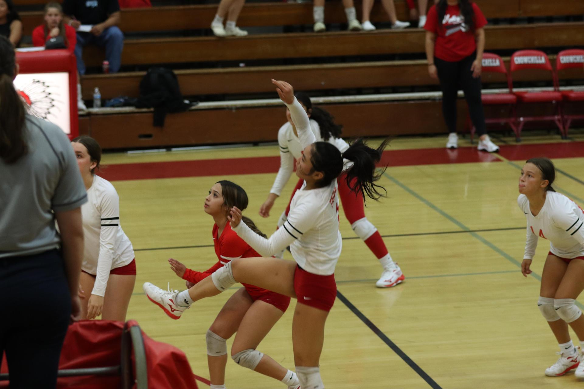 varsity volleyball players in action against liberty