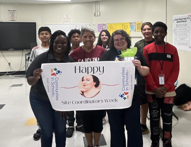 Ms. Strickland with CIS students and principal