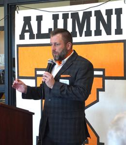 Nick Wake, Class of 2005, introduces his mother as the distinguished alumni.