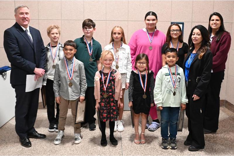 Students smiling with board members.