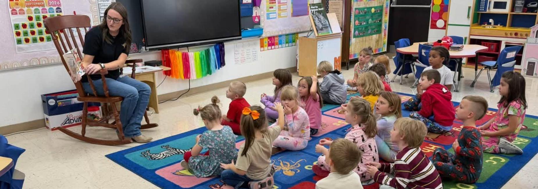 Deputy 911 Director Lakin Hess reads to students at CES as part of their Community Connections program.