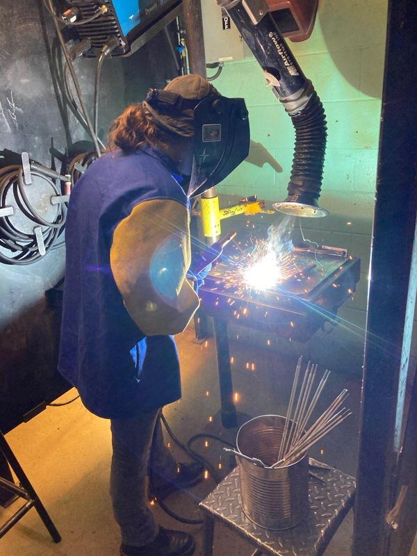 Cti adult student welding pipe in class