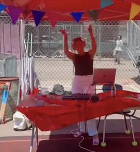 a student being a DJ at the senior event