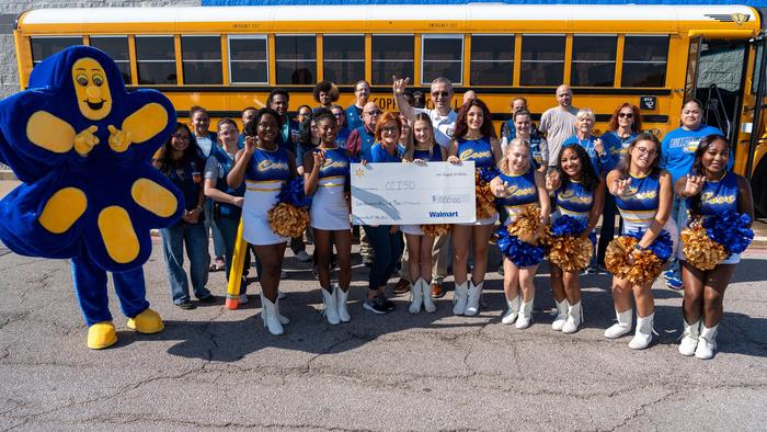 A group of people smiling and holding a ceremonial check